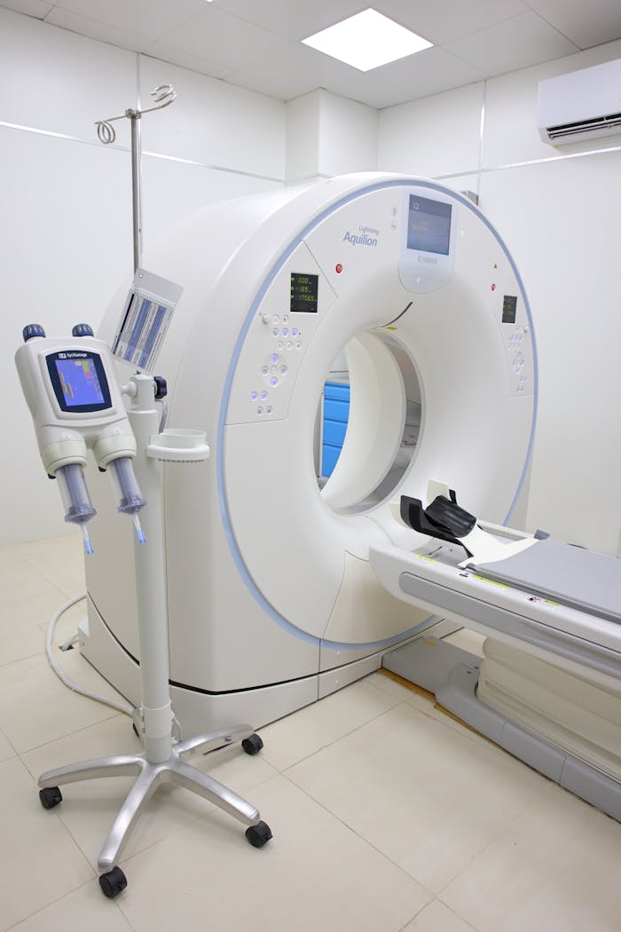 gallery-2 Bright hospital room featuring a modern MRI machine and related technology.