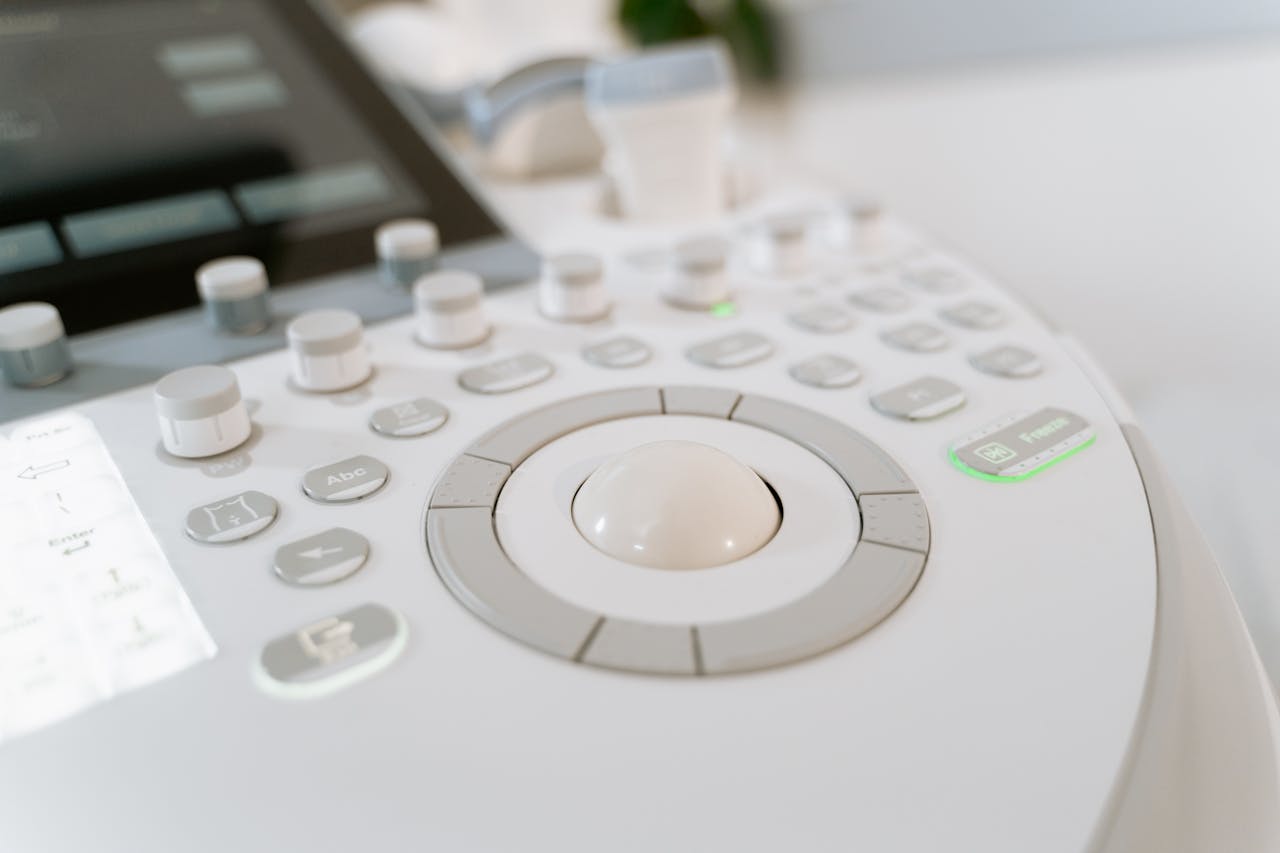 about-01 Detailed close-up of ultrasound machine controls in a medical facility.